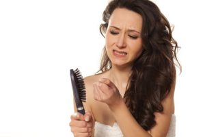 girl is very nervous about the loss of hair on white background